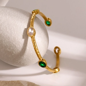 18k gold plated stainless steel hammer-textured cuff bangle with emerald and white gems