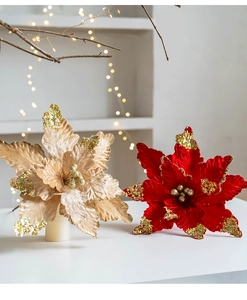 Detailed view of champagne and red velvet Christmas flowers with sparkling gold glitter
