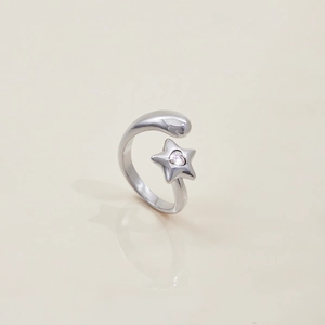 Macro view of silver stainless steel open ring with star shape and heart crystal detail