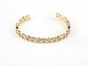 Detailed view of open cuff bracelet with square-cut white zircons in gold plating