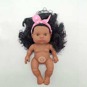 Detailed close-up of a realistic dark-skinned baby doll with a pink headband and sound device