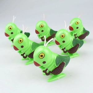 Close-up of a set of six green wind-up insect toys with vibrant wings on white background