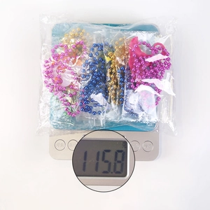 Macro shot showing 115.8g weight of colorful Halloween beaded necklaces in packaging