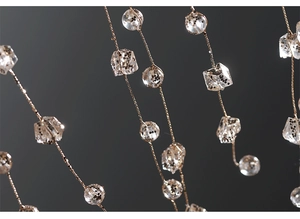 Macro detail of clear acrylic icicle drops with gold glitter and metallic wire threads