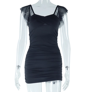 Detail of black slim-fit mini dress with sheer mesh sleeves and ruched fabric texture