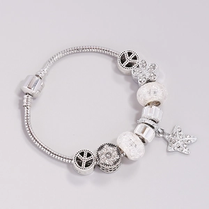 Silver snake chain bracelet featuring green glass floral beads and starfish charms