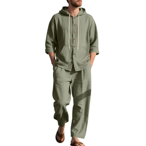 Detail view of sage green men linen hooded shirt and pants showing breathable fabric texture