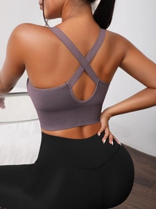 Seamless purple yoga bra with cross-back straps and wide ribbed hem for fitness support