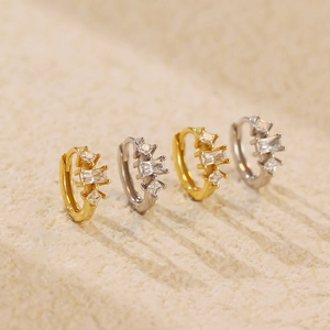 Detail of s925 silver hoop earrings with gold and silver finishes and cubic zirconia
