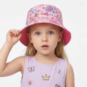 Detail of pink kid's bucket hat with cartoon princess castle and heart patterns