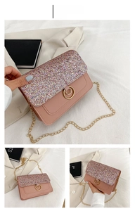 Detailed close-up of pink sequin crossbody bag with gold chain and circular metal lock