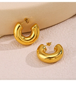 Detail of 18K gold plated chunky C-shaped hoop earrings with a mirror polished finish