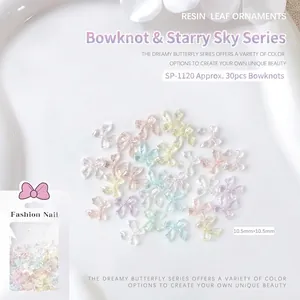 Macro detail of mixed aurora resin bow nail charms with glitter finish and 10.5mm sizing