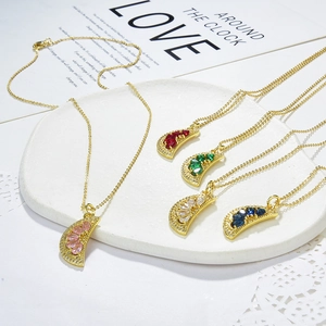 Detail of colorful zircon fruit pendants on golden O-chains in pink, red and blue