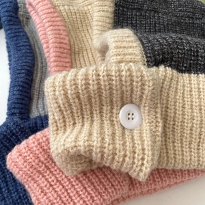 Close-up of chunky knit texture and white button details on Balaclava knitted caps