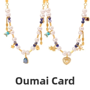 Macro view of double layered pearl and gemstone necklaces with dragonfly and heart charms