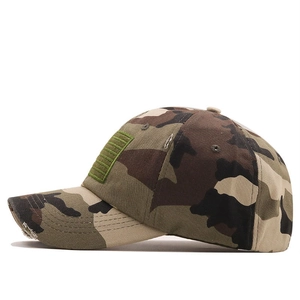 Detailed close-up of tactical camo baseball cap featuring a distressed brim and flag patch