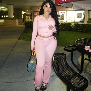 Detailed view of pink hooded zip-up cardigan and matching slim pants set for women