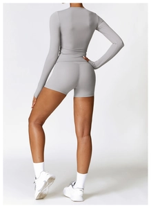 Rear view of grey long sleeve fitness top and tight shorts with high-stretch fabric
