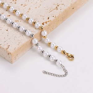 Vintage pearl necklace with gold and silver beads on a natural stone base