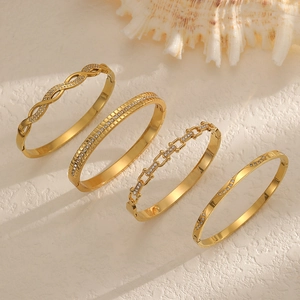 Set of four 18K gold plated stainless steel bangles with zircon and textured patterns