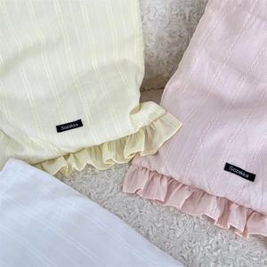 Detailed close-up of vertical hollow stripes and ruffled edges on soft cotton fabric