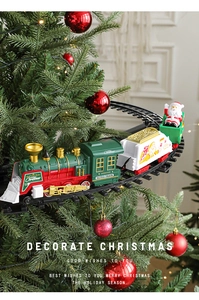 Electric Christmas train set mounted on tree branches with vintage locomotive and cars