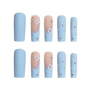 Blue French press-on nails with 3D white flowers, pearls, and rhinestones on long coffin shape