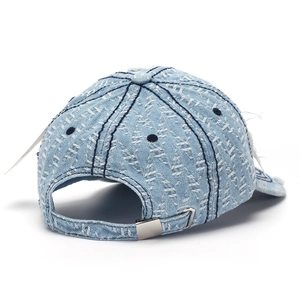 Detail of light blue distressed denim baseball cap with herringbone texture and silver buckle