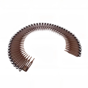 Detail of a brown circular hair comb band with clear rhinestones on a white background