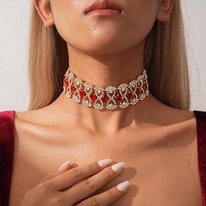 Detail of vintage gold choker necklace with red marquise rhinestones on model neck