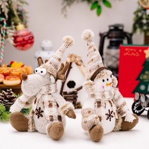 Detailed view of plush reindeer and snowman Christmas dolls with cozy holiday decor