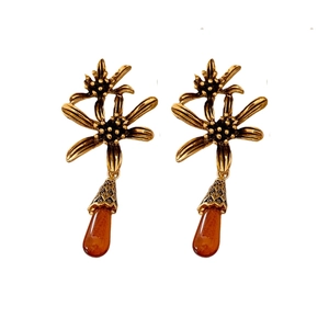 Vintage gold flower earrings with amber teardrop pendants in retro aesthetic