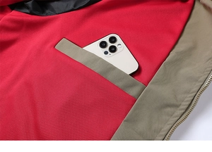 Detail of jacket interior showing breathable red mesh lining and functional phone pocket