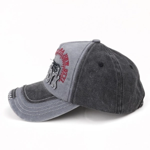 Detail of washed baseball cap showing red embroidery and vintage distressed brim finish