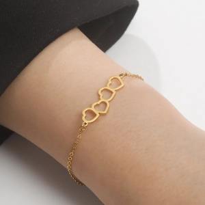 Gold hollowed heart bracelet in stainless steel shown on wrist for daily wear