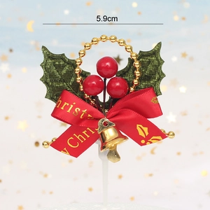 Detailed Christmas cake topper with holly leaves, red berries, and a small golden bell
