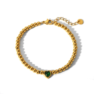 Detail of 18K gold stainless steel beaded bracelet with green heart gemstone and lobster clasp