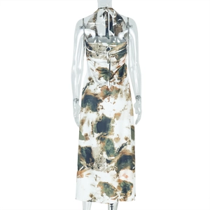 Detail of backless printed maxi dress featuring halter neck tie and abstract earthy patterns
