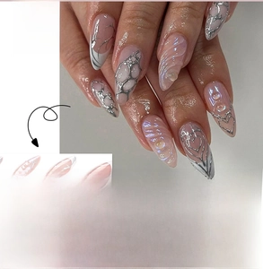 Detailed view of 3D embossed wavy nail tips with metallic silver lines and pearl accents