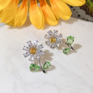 Elegant daisy stud earrings with yellow gemstone center and green leaves petals