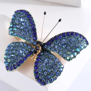 Elegant butterfly brooch in gold alloy with blue and iridescent rhinestones for women