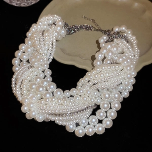 Detailed macro view of multi-layer knotted pearl necklace with shimmering rhinestones