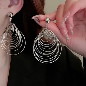 Exaggerated silver multi-layer interlocking hoop earrings with high polish metallic finish