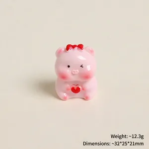 Detailed view of pink resin pig figurine holding red heart with size measurements