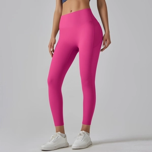 Detail of rose pink yoga leggings featuring a high waistband and functional side pockets
