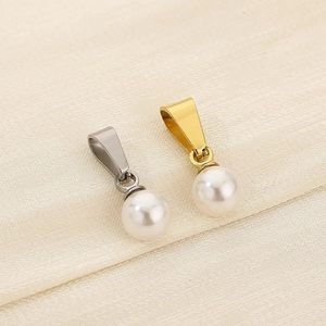 Macro view of gold and silver plated white pearl pendants for DIY jewelry making