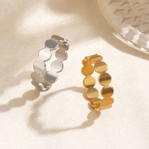 Minimalist geometric circle rings in gold and silver finish on textured fabric
