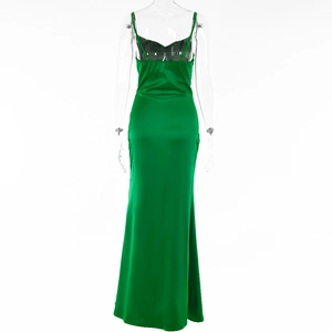 Detail of the backless green satin evening dress featuring a high slit and elegant design