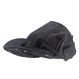 Close-up of black breathable mesh texture and bronze metal vent on the newsboy hat